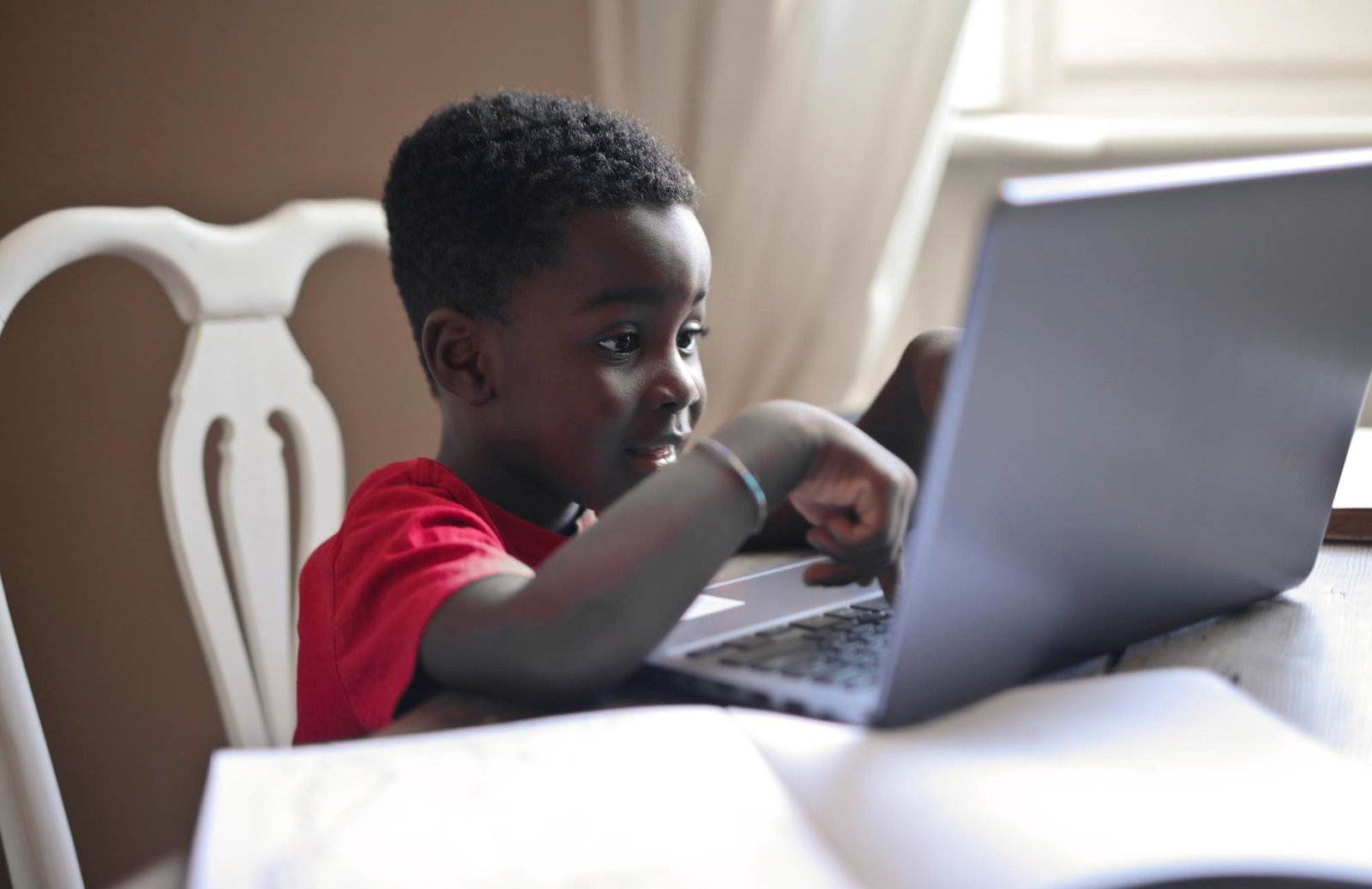 Portrait of black child while doing homework<br />
